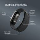 Image of the Band 2.0 fitness tracker on a dark background with the heading 'Built to be worn 24/7.' Labeled callouts point to different features: '14-day battery,' 'Patented soft-touch material,' 'Always tracking,' and 'Lightweight, breathable' strap.