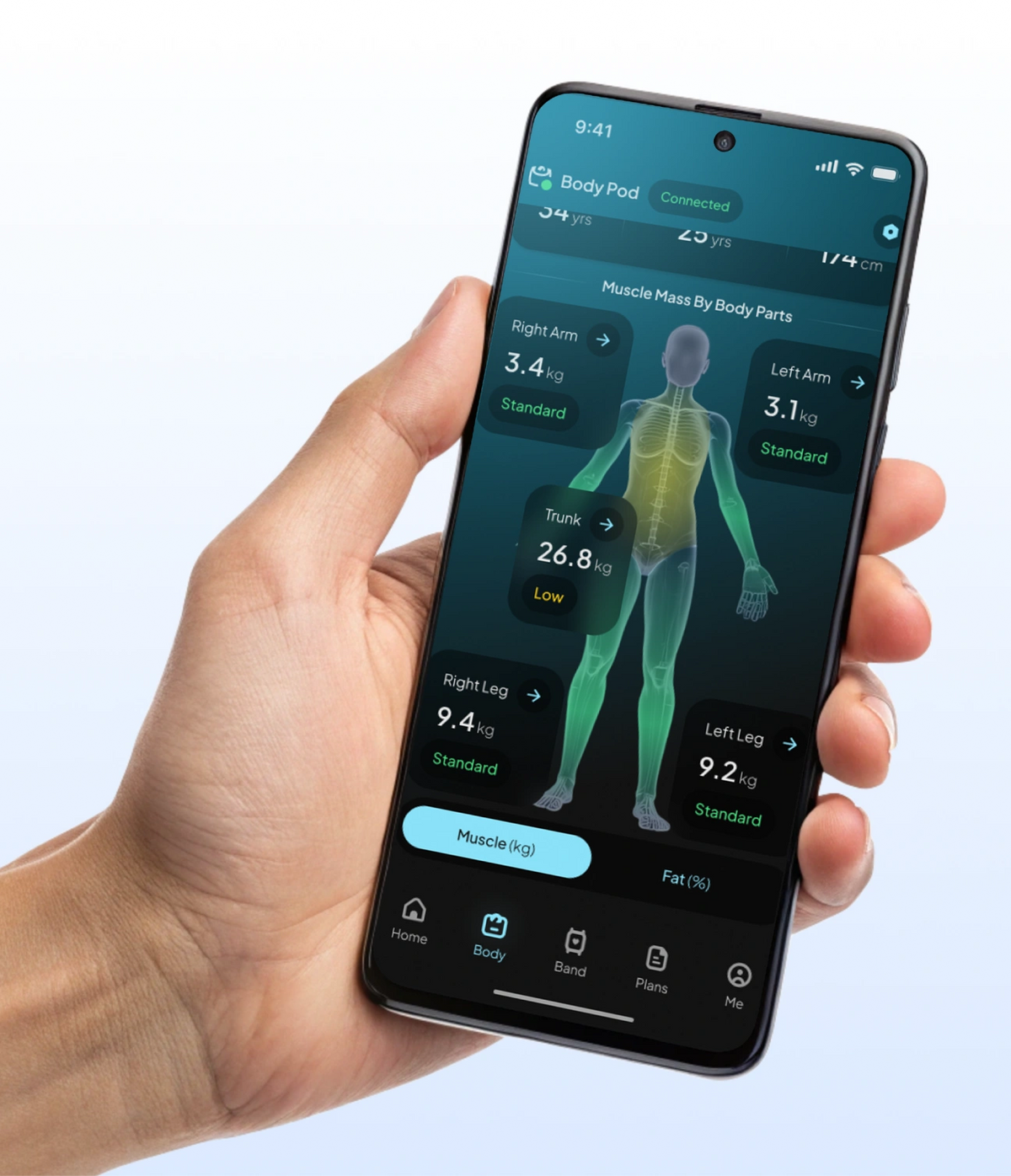 Hand holding smartphone displaying Hume Body Pod app with segmental muscle mass analysis, showing measurements for arms, legs, and trunk.