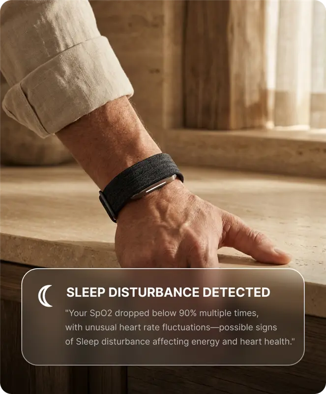 Close-up of a person wearing a Hume Band 2.0 while resting a hand on a countertop, with an overnight sleep summary on screen.